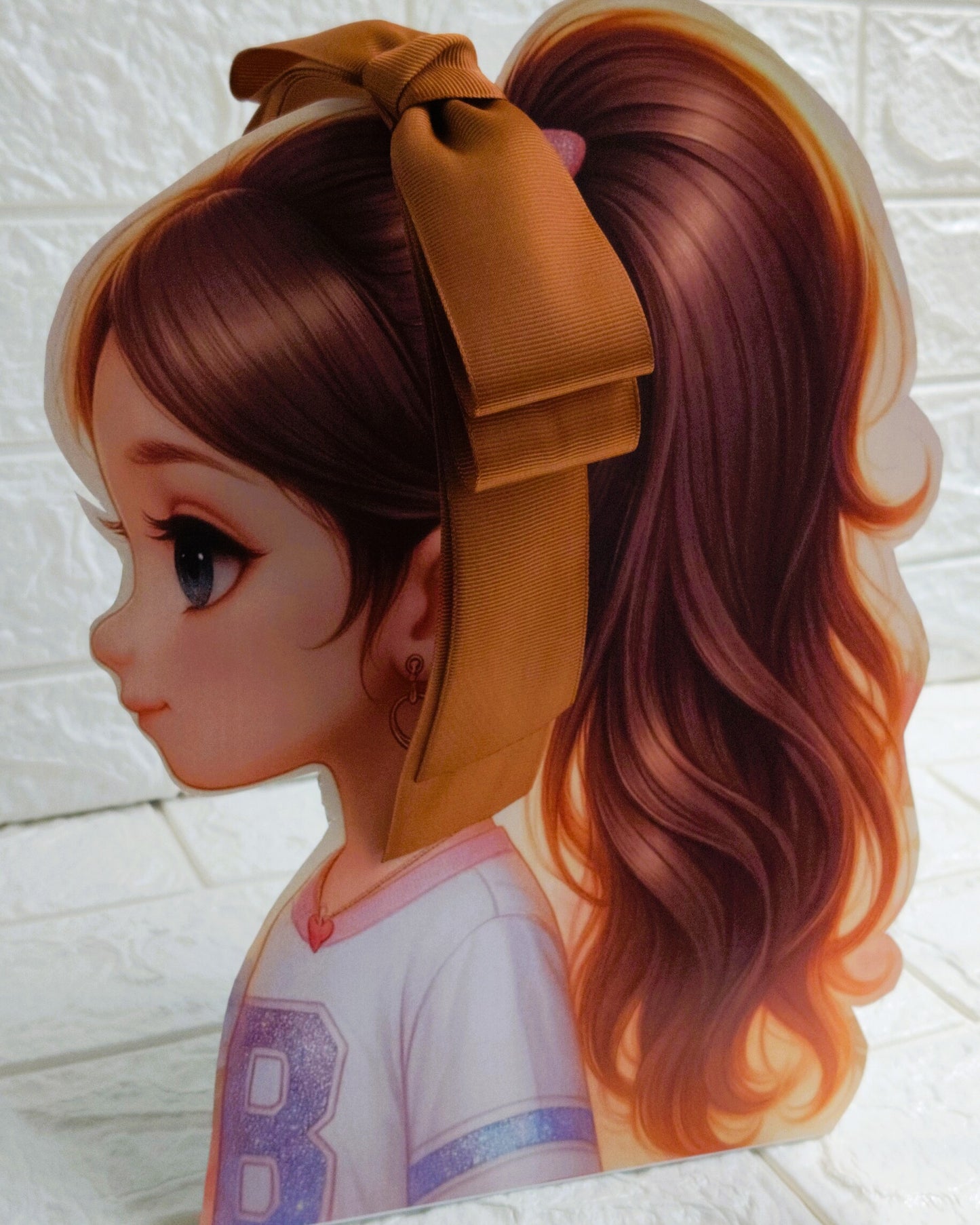 Illustration of a girl with brown hair in pigtails wearing a TinyShiny Bow Copper color