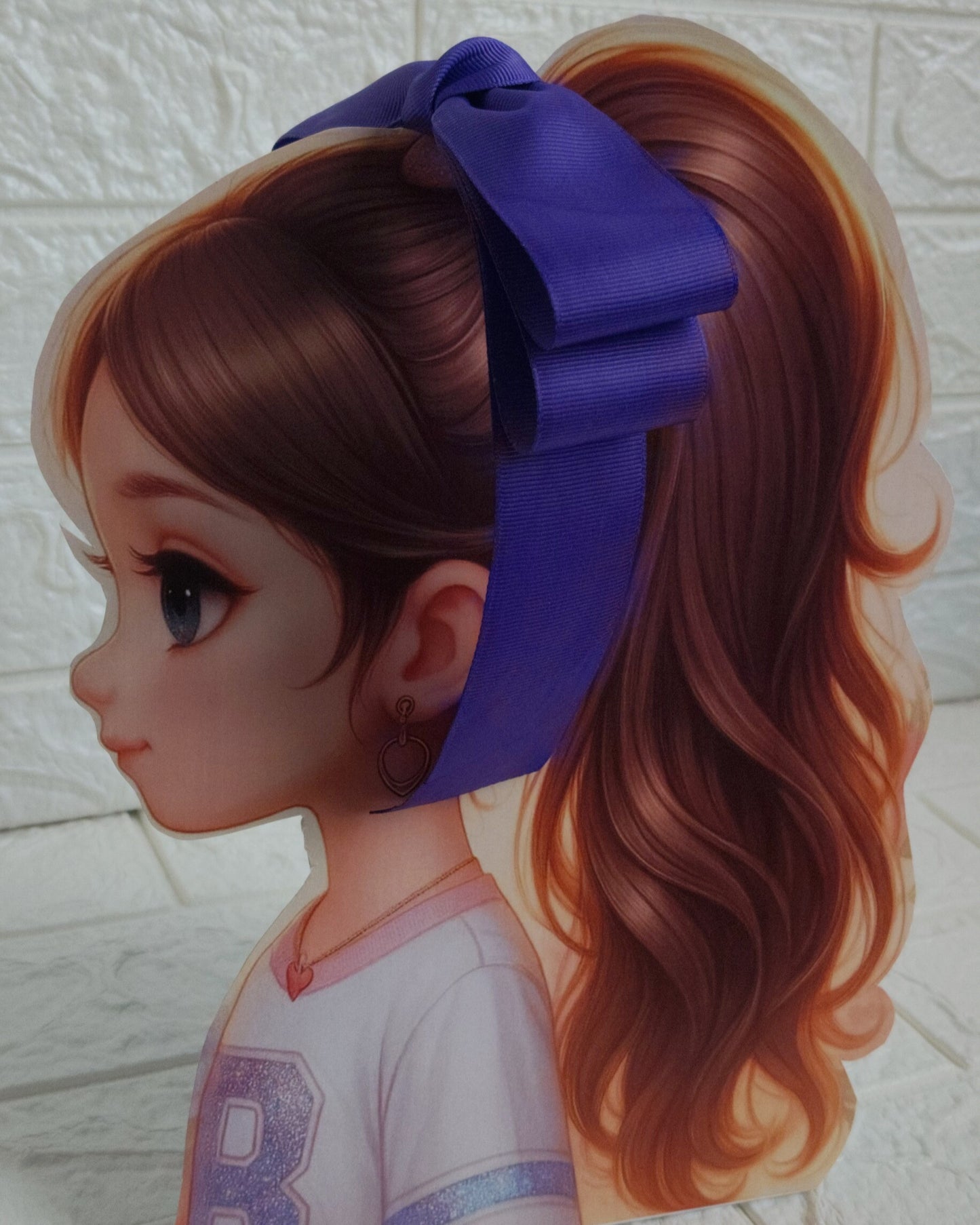 Illustration of a girl with brown hair in pigtails wearing a TinyShiny Bow Deep Purple color 