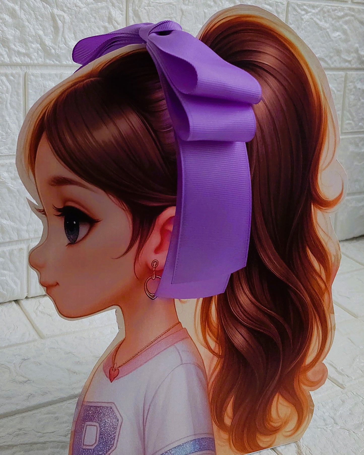 Illustration of a girl with brown hair in pigtails wearing a TinyShiny Bow Light Purple color