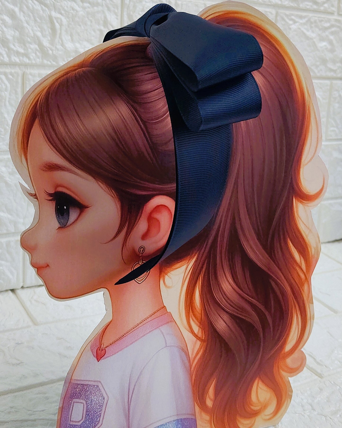 Illustration of a girl with brown hair in pigtails wearing a TinyShiny Bow Navy Blue color 