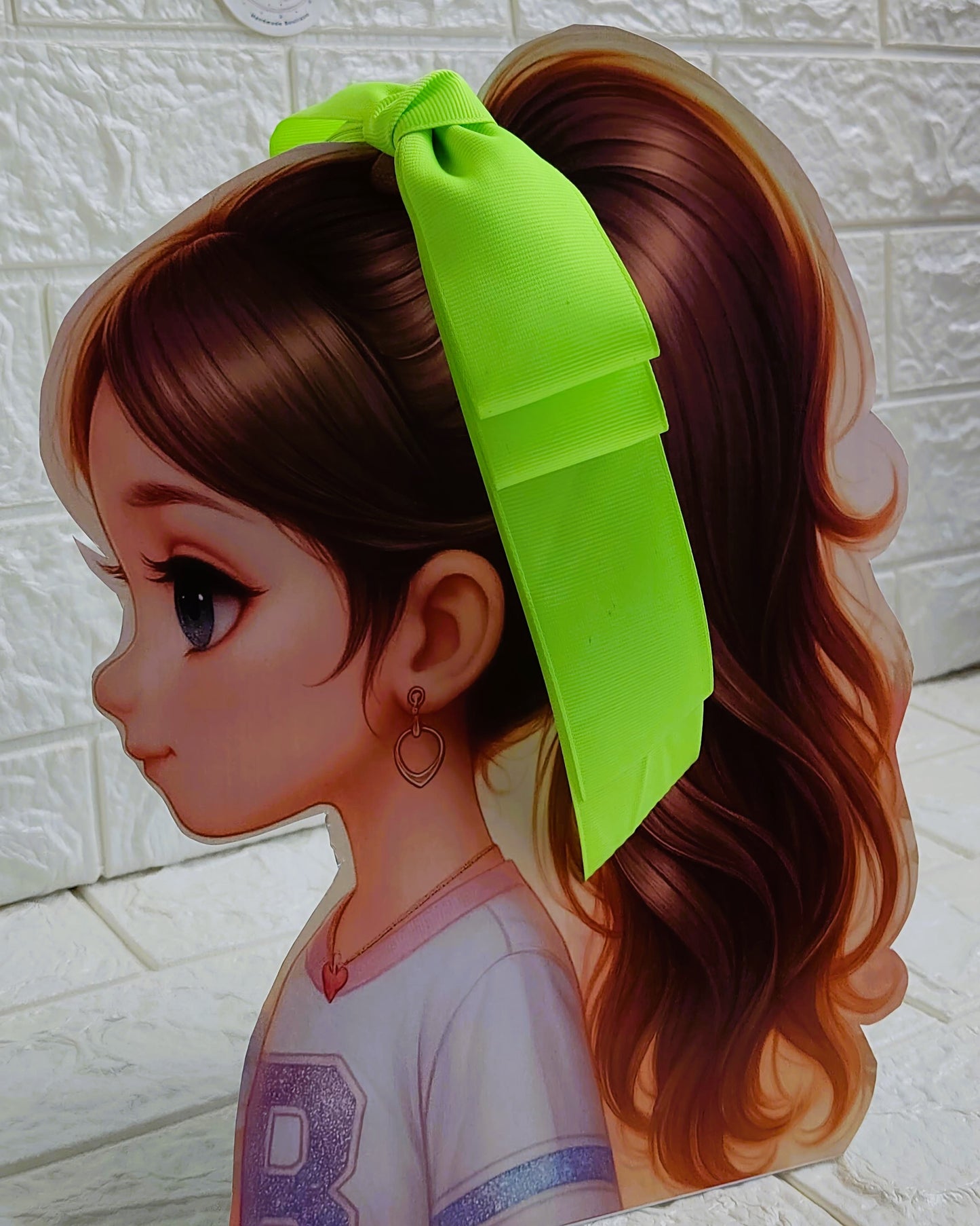 Illustration of a girl with brown hair in pigtails wearing a TinyShiny Bow Neon Green color 