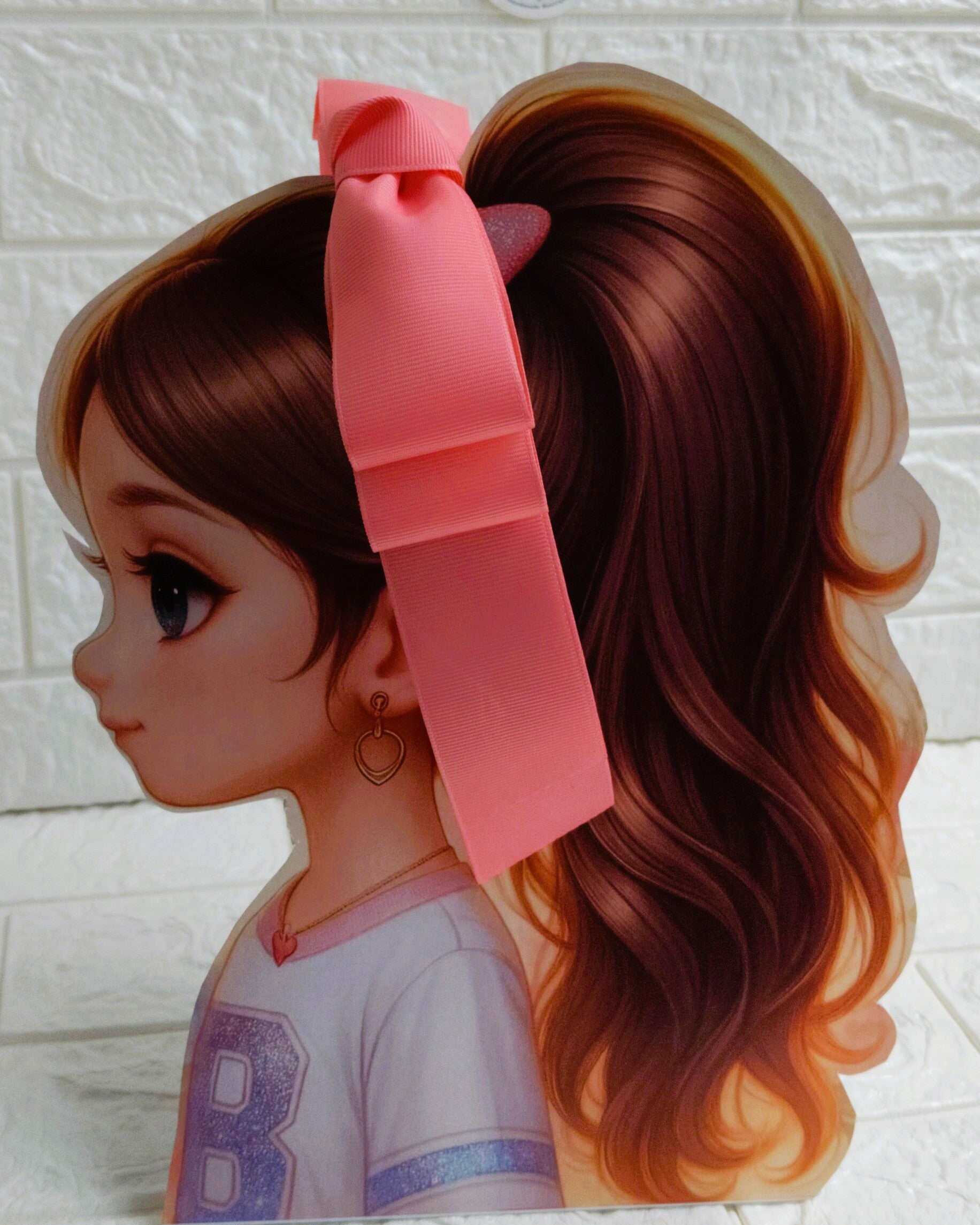 Illustration of a girl with brown hair in pigtails wearing a TinyShiny Bow Rose Pink color