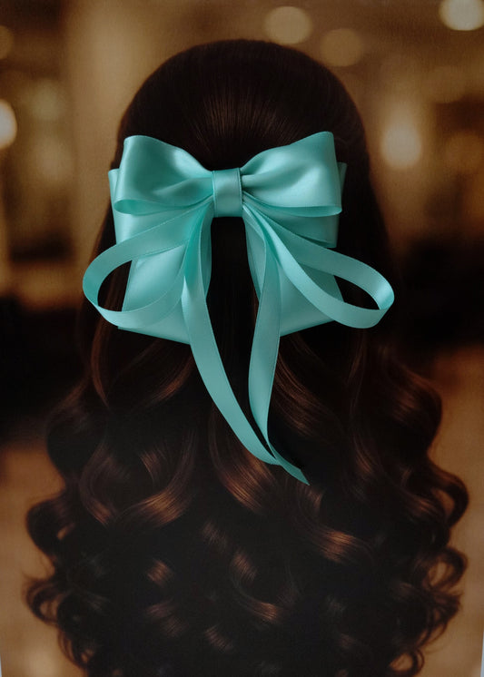 Back view of a girl with long curled hair wearing a large bright Forsty Mint satin bow - perfect for festive or formal occasions - TinyShiny