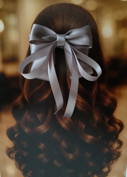 Back view of a girl with long curled hair wearing a large bright Grey satin bow - perfect for festive or formal occasions - TinyShiny