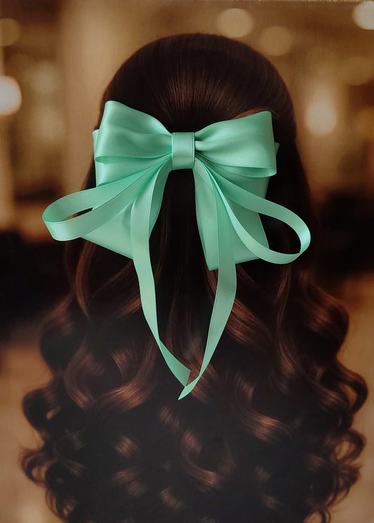 Back view of a girl with long curled hair wearing a large bright mint green satin bow - perfect for festive or formal occasions - TinyShiny