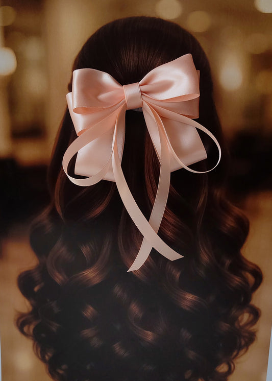 Back view of a girl with long curled hair wearing a large bright peach satin bow - perfect for festive or formal occasions - TinyShiny
