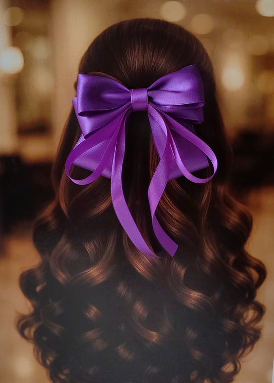 Back view of a girl with long curled hair wearing a large bright purple satin bow - perfect for festive or formal occasions - TinyShiny